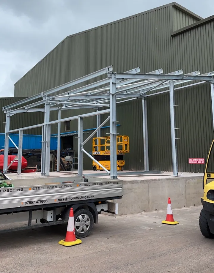 Scaffolding along a newly clad industrial roof